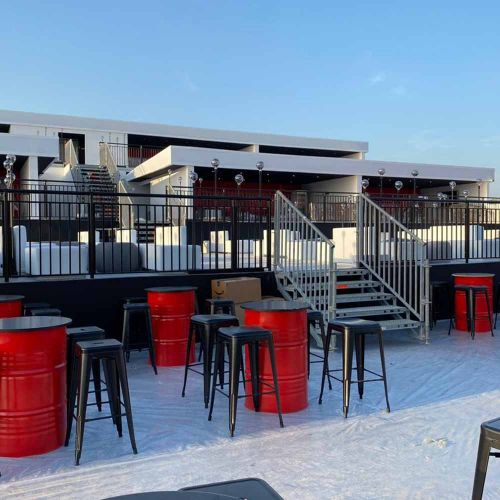 Event Venue Fabrication with Red Barrels and Stage Setup in Ras Al Khaimah